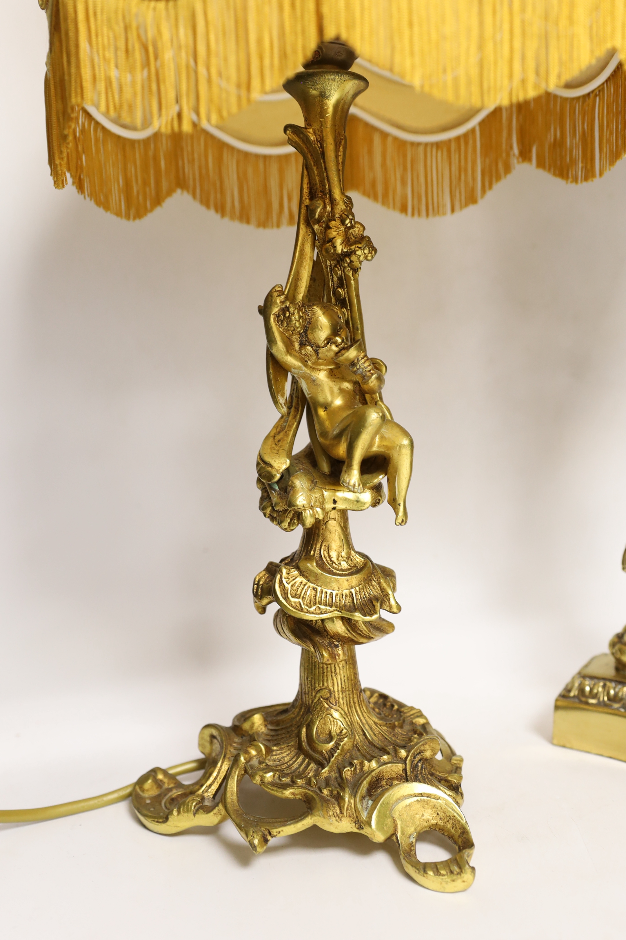 A Victorian-style brass and ceramic table lamp with beaded shade, and one other with cherub figure, tallest 62cm